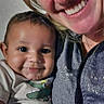 baby, child, woman, smile, happy, indoor, portrait, person, clothing, face, drool, nose_piercing, zipper, casual_wear, affection, close_up, family, skin, head, eyes
