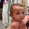 Christian is registered to the contest to win money with this photo: baby, child, indoor, person, towel, clothing, face, arm, hair, skin, expression, holding, adult, background, room, hanger, fabric, casual, curious, portrait