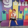 Kash is registered to the contest to win money with this photo: toddler, child, pirate_costume, smile, barefoot, balloons, colorful_background, stars, seated, playful, indoor, costume, happy, cute, decorations, young_child, festival, celebration, event, fun