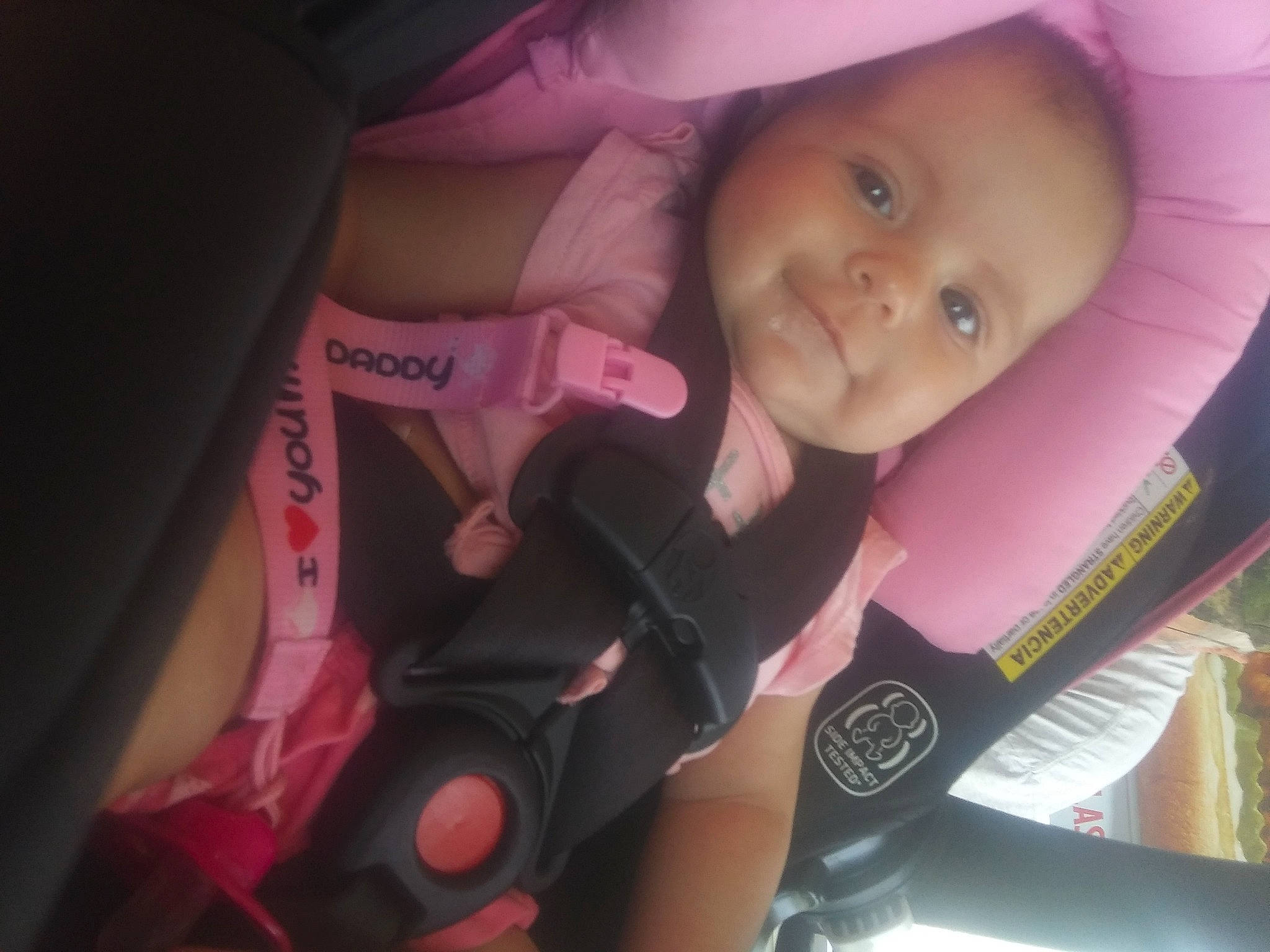 Michelle is registered to the contest to win money with this photo: baby, baby_carriage, baby_toddler_clothing, cheek, child, eye, face, finger, happy, iris, lip, magenta, nail, person, pink, skin, smile, tire, toddler, violet