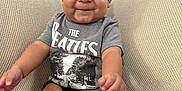 Liam is registered to the contest to win money with this photo: baby, child, smiling, sitting, indoor, couch, clothing, tshirt, cute, happy, face, person, infant, legs, hands, foot, knit, home, young, portrait