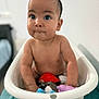 baby, tub, toy, child, indoor, water, cute, expression, face, skin, small, sitting, playful, blue, purple, red, white, person, infant, bathroom