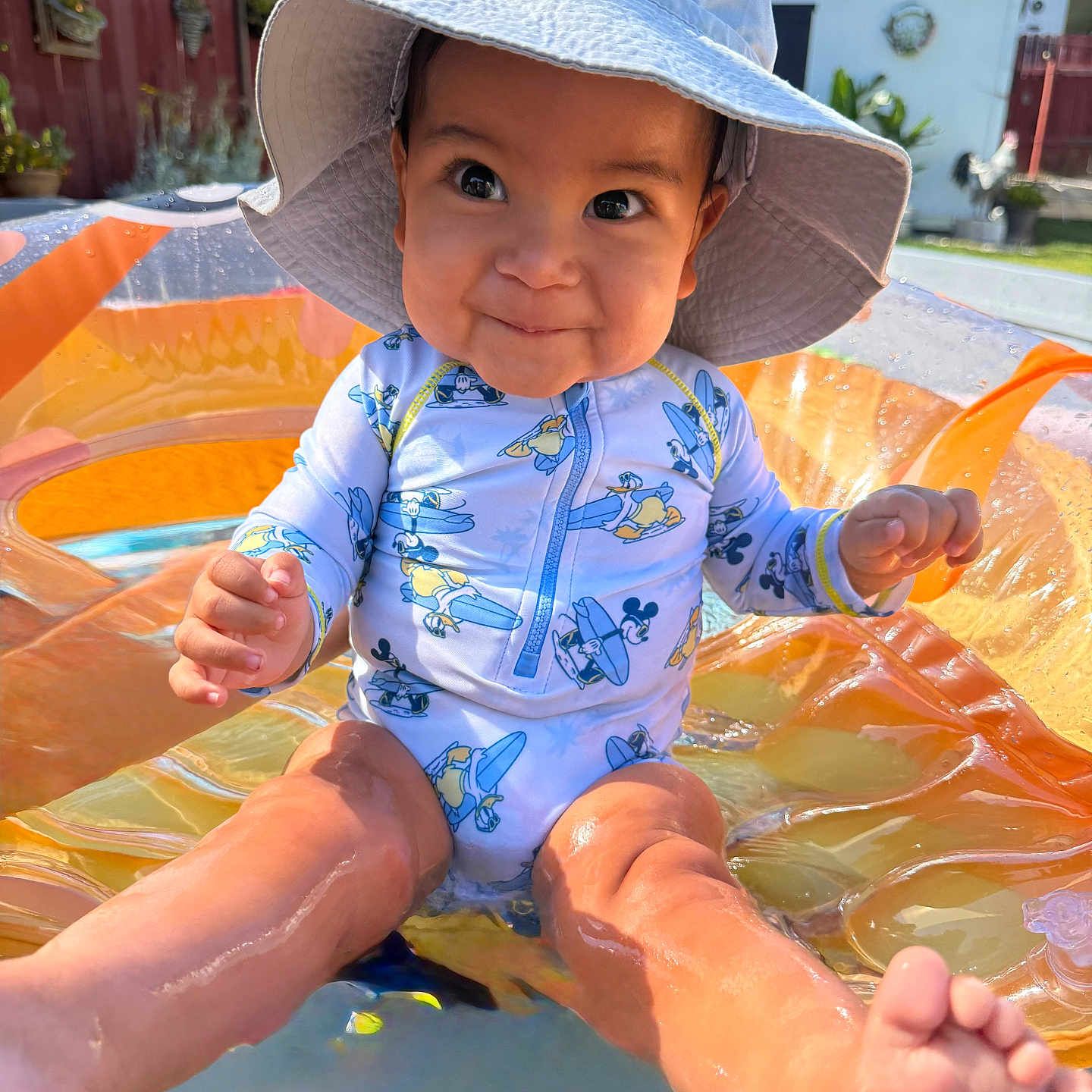 Liam joined the competition — help win amazing prizes! baby, backyard, child, face, feet, happy, hat, inflatable_pool, legs, mickey_mouse, outdoor, playful, pool, smiling, splashing, summer, sunny, swimsuit, vacation, water