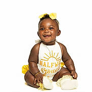 Maori joined the competition — help win amazing prizes! baby, smiling, sitting, white_background, yellow_bow, yellow_accents, cute_outfit, infant, happy, portrait, child, adorable, studio_shot, bright, young, fashion, accessory, feet, hand, face