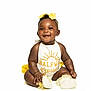 baby, smiling, sitting, white_background, yellow_bow, yellow_accents, cute_outfit, infant, happy, portrait, child, adorable, studio_shot, bright, young, fashion, accessory, feet, hand, face