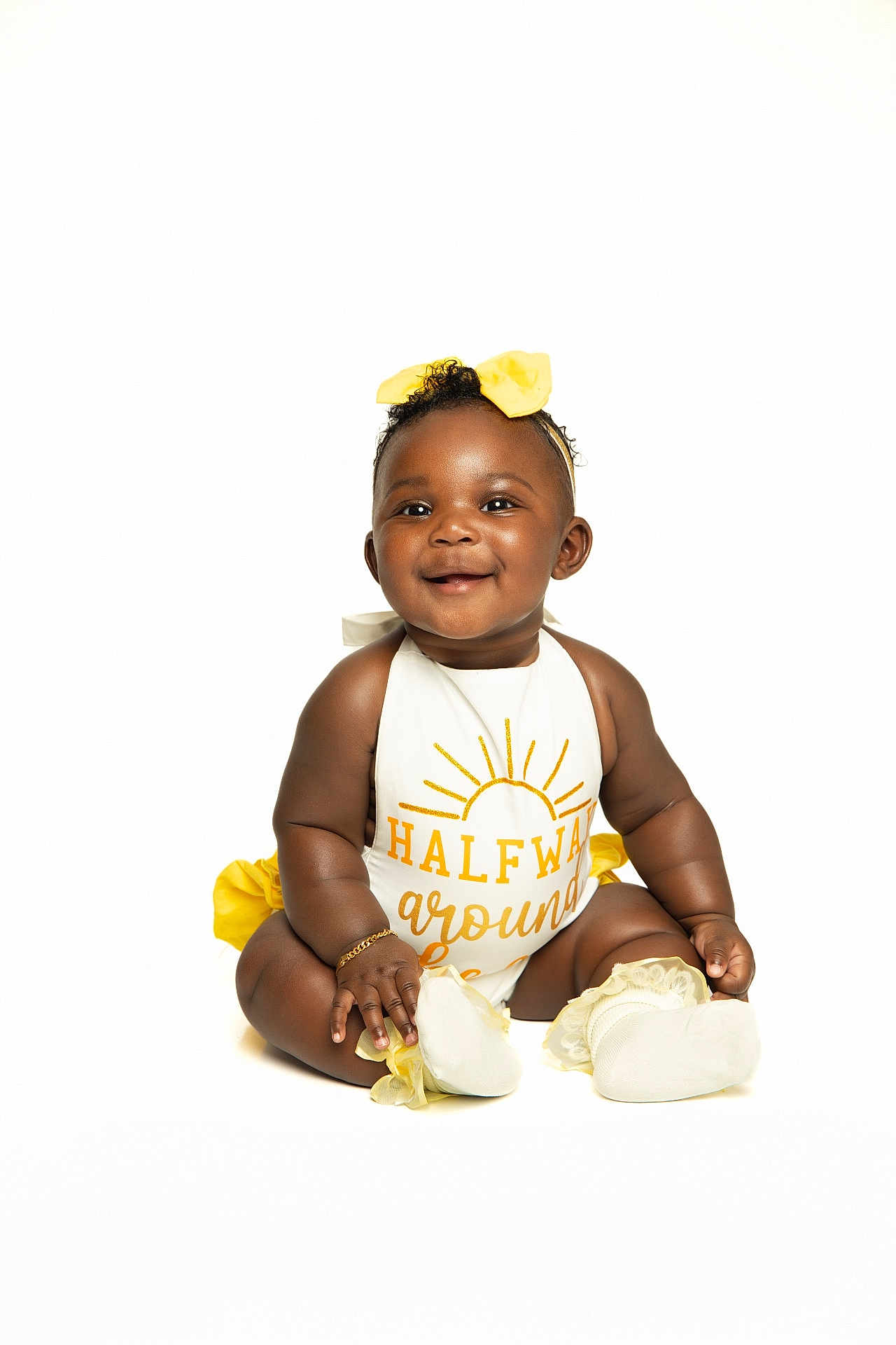 Maori joined the competition — help win amazing prizes! baby, smiling, sitting, white_background, yellow_bow, yellow_accents, cute_outfit, infant, happy, portrait, child, adorable, studio_shot, bright, young, fashion, accessory, feet, hand, face