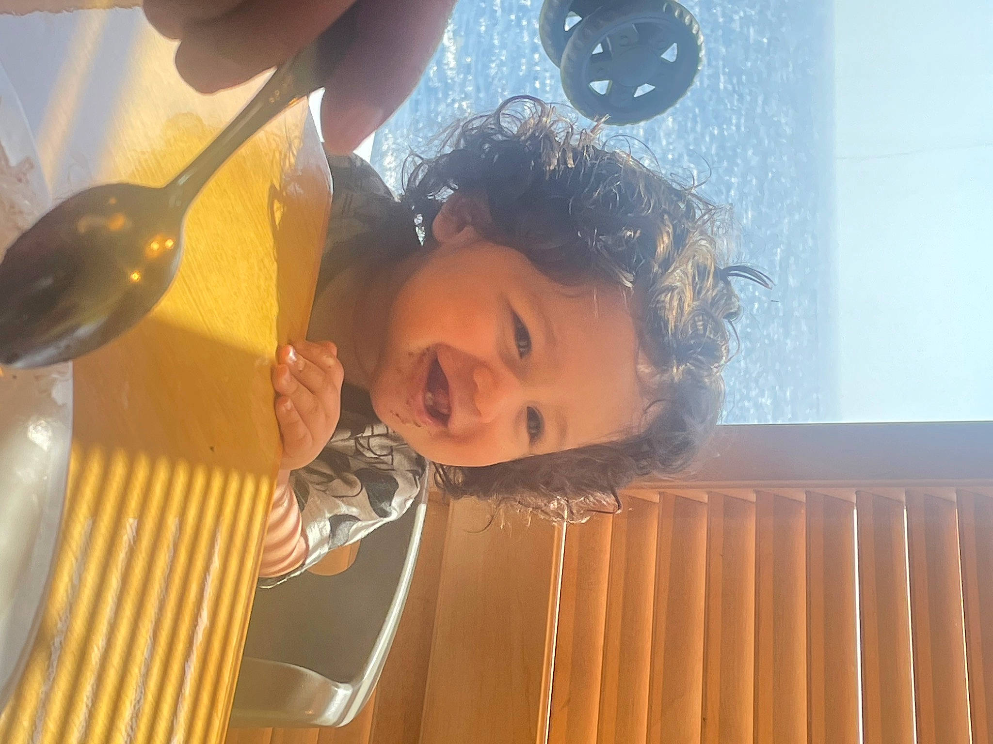 Juan is registered to the contest to win money with this photo: ceiling, child, cutlery, fun, glass, happy, joy, kitchen_utensil, leisure, person, play, room, sky, smile, spoon, tableware, toddler, water, wood