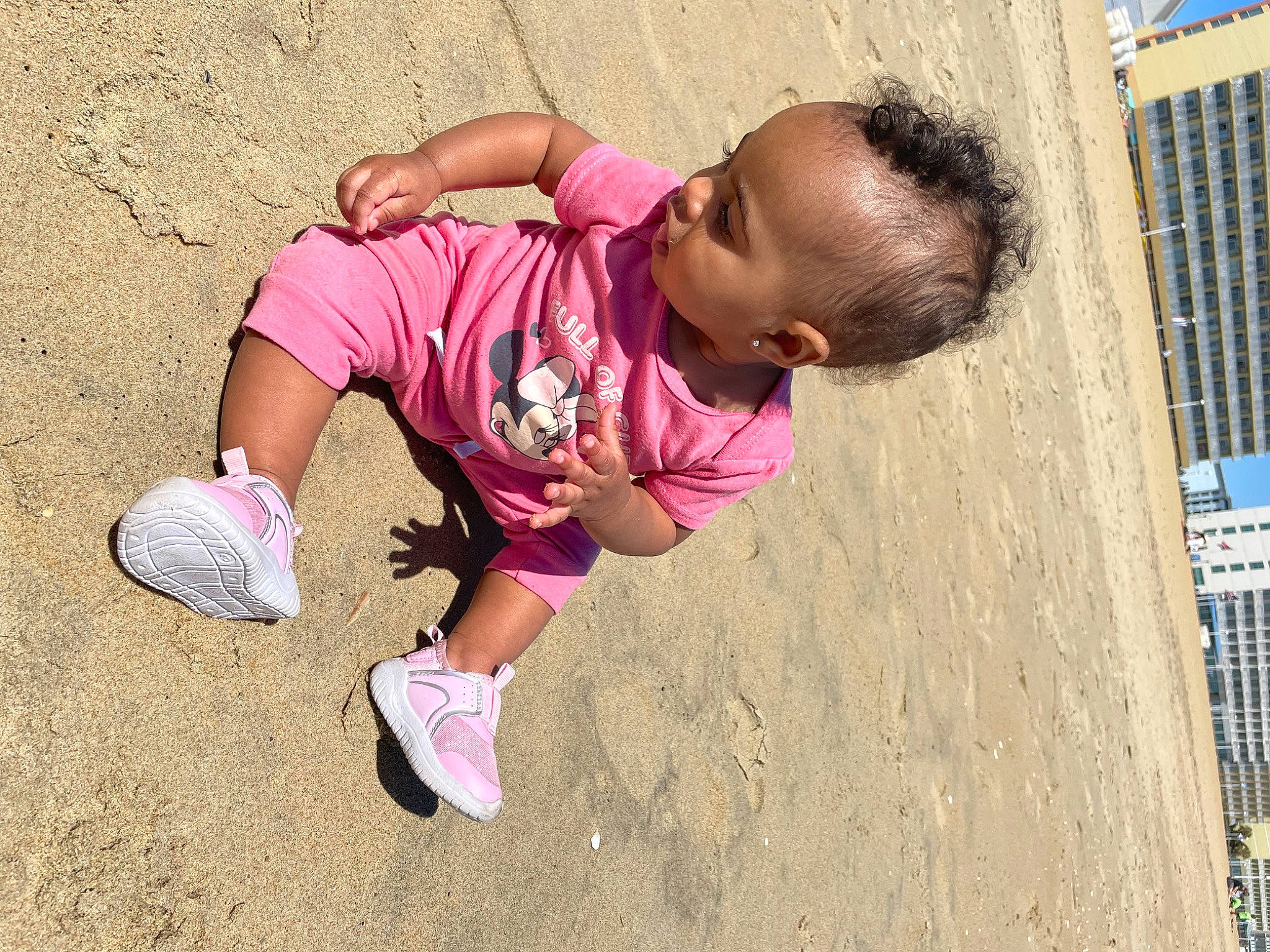 Cienna is registered to the contest to win money with this photo: baby_toddler_clothing, building, city, foot, fun, happy, human_leg, leg, leisure, magenta, people_in_nature, person, pink, sleeve, sneakers, sock, soil, thigh, toddler, tree