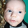 Elijah joined the competition — help win amazing prizes! baby, black_shirt, blanket, blue_eyes, child, close_up, clothing, cute, eyes, face, gray_shirt, head, indoors, infant, looking_at_camera, photography, portrait, skin, teal_background, textured_fabric