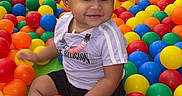 Emoni joined the competition — help win amazing prizes! ball_pit, bright_colors, child, colorful_balls, cute, fun, hair_bows, happy, indoor_playground, leisure, person, plastic_balls, play_area, playtime, seated, shorts, smiling, toddler, tshirt, young_child