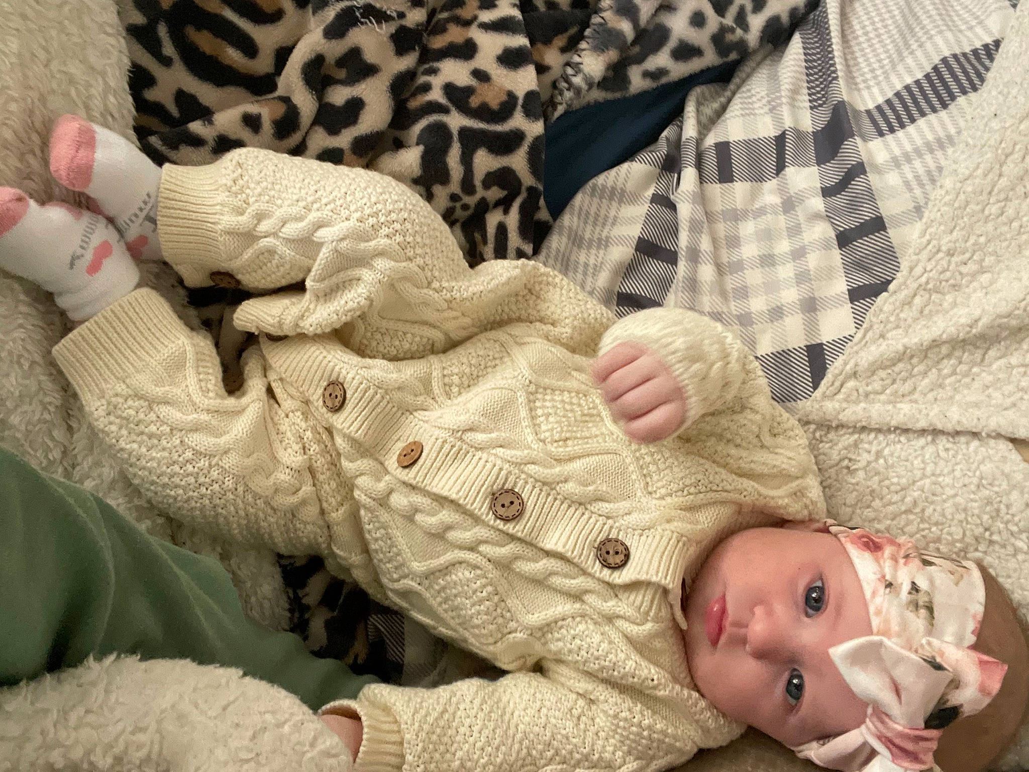 Emery is registered to the contest to win money with this photo: arm, baby, baby_toddler_clothing, comfort, finger, gesture, hand, head, headwear, human, human_body, leg, linens, nail, organ, people, person, skin, sleeve, textile