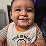baby, smiling, bib, face, child, indoor, cute, happy, person, portrait, closeup, clothing, infant, skin, hand, expression, sitting, young, cute_face, joy