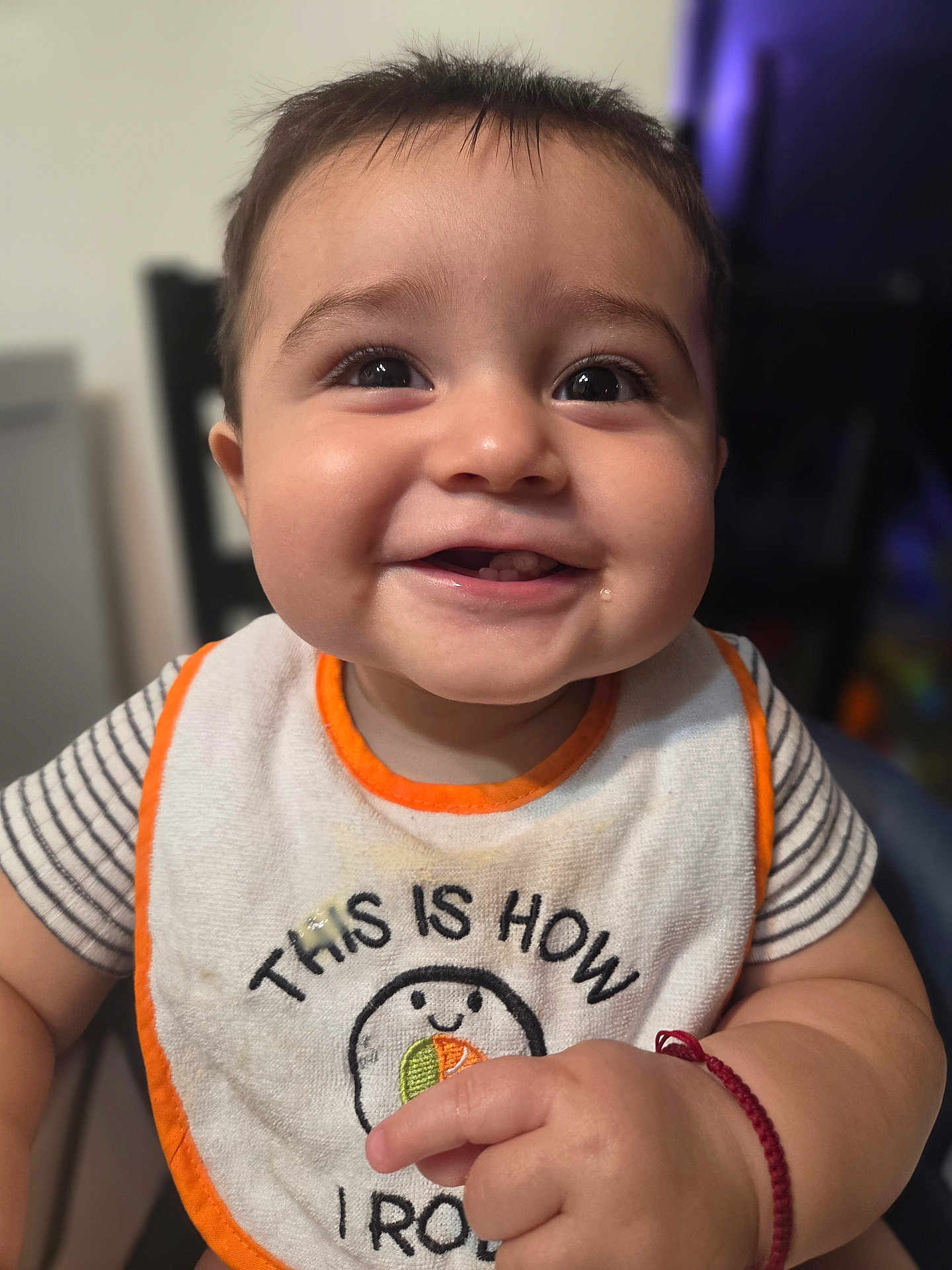 Matthew is registered to the contest to win money with this photo: baby, smiling, bib, face, child, indoor, cute, happy, person, portrait, closeup, clothing, infant, skin, hand, expression, sitting, young, cute_face, joy