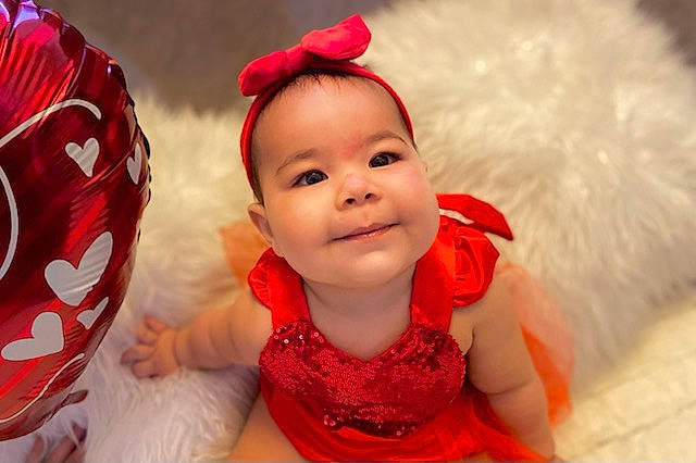 Melianna joined the competition — help win amazing prizes! baby, baby_toddler_clothing, child, costume_hat, dress, event, fashion_accessory, fun, hair_accessory, happy, head, headband, headpiece, joy, person, pink, red, skin, sleeve, smile