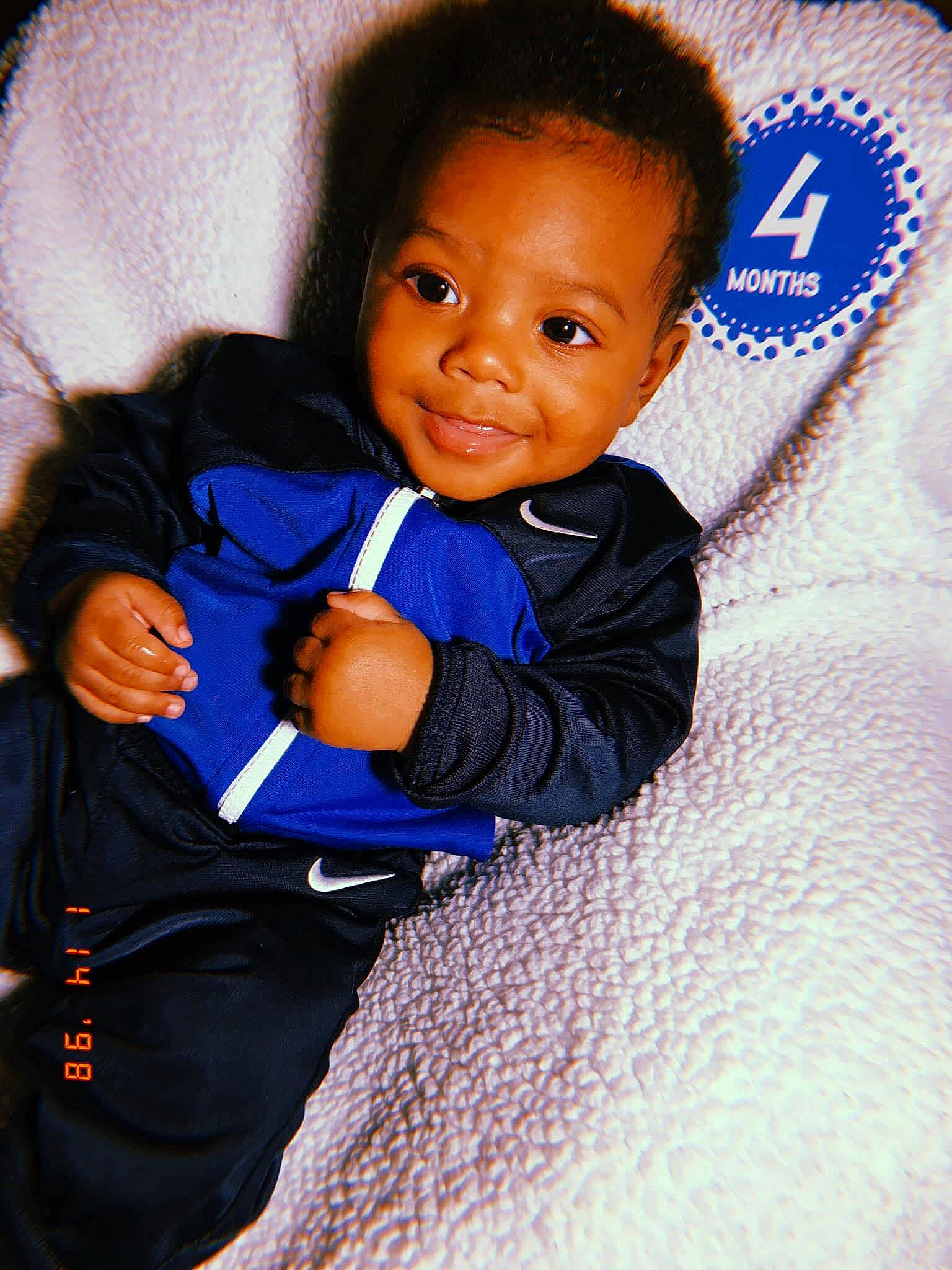 Alandis is registered to the contest to win money with this photo: azure, baby, baby_toddler_clothing, cheek, child, comfort, cool, electric_blue, finger, flooring, fun, gesture, hairstyle, happy, joy, nose, person, skin, sleeve, smile