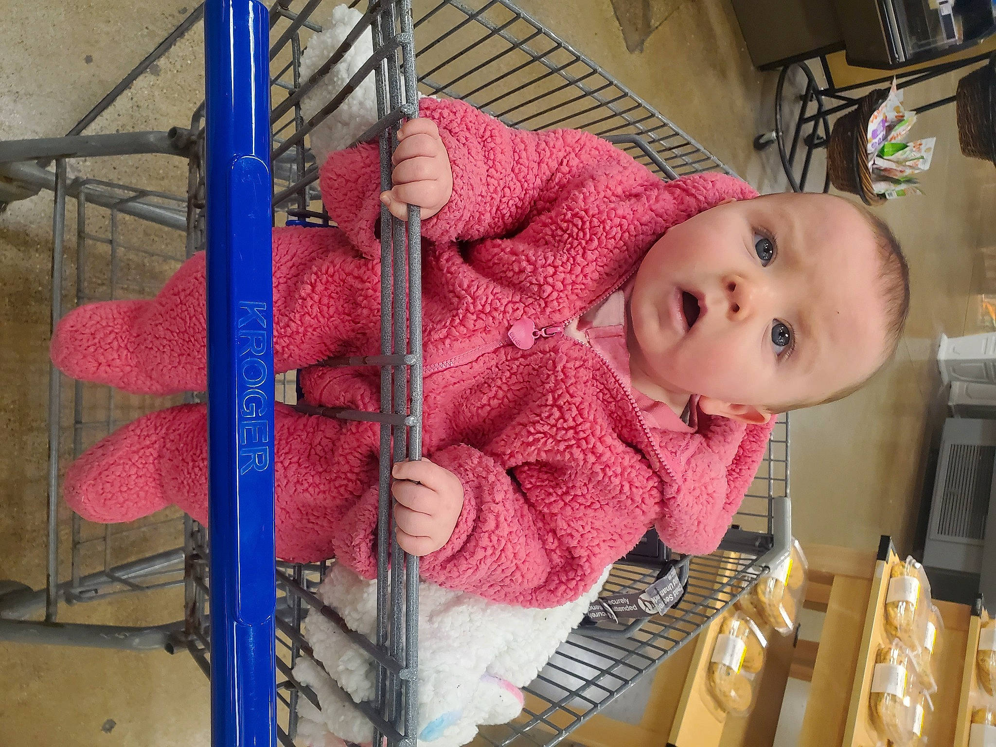 Skylee is registered to the contest to win money with this photo: baby, baby_products, baby_safety, baby_toddler_clothing, cheek, child, human_body, linens, magenta, pattern, person, pink, room, skin, smile, surprise, textile, thread, toddler, weaving