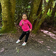 Jayanne Rose Saldo joined the competition — help win amazing prizes! black_pants, branches, child, forest, ground, hoodie, leaves, moss, nature, outdoor, peace_sign, person, pink_clothing, playful, smiling, sneakers, standing, sunlight, tree, young