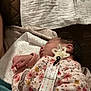baby, newborn, sleeping, pacifier, clothing, floral_pattern, hand, towel, bed, blanket, indoor, person, infant, comfort, rest, cute, skin, hair, soft, sleep