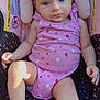 baby, infant, child, car_seat, pink_clothing, headband, bow, blue_eyes, onesie, warning_label, sitting, cute, soft_light, indoors, comfortable, portrait, skin, hand, foot, relax