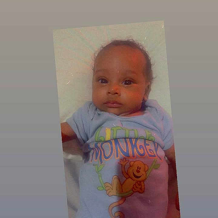 Lana joined the competition — help win amazing prizes! baby, infant, child, tshirt, monkey, animal_print, lying_down, portrait, face, curly_hair, cute, colorful_clothing, white_background, expression, young_child, smiling, indoors, soft_lighting, gradient_background, person