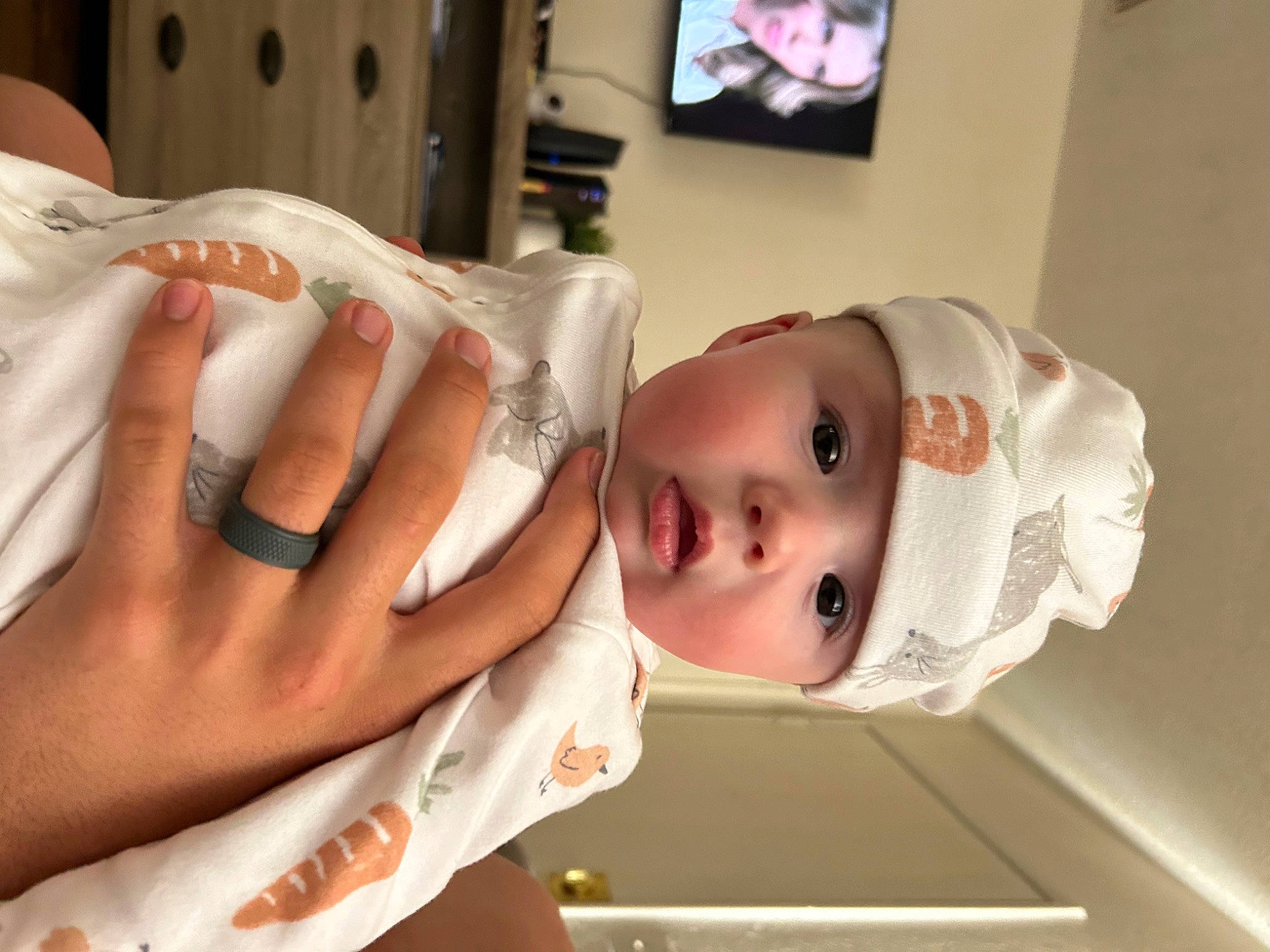 Maelynn is registered to the contest to win money with this photo: abdomen, baby, chest, child, eyelash, flesh, gesture, hat, headwear, human_leg, lip, mouth, nail, person, room, service, skin, television, thumb, toddler