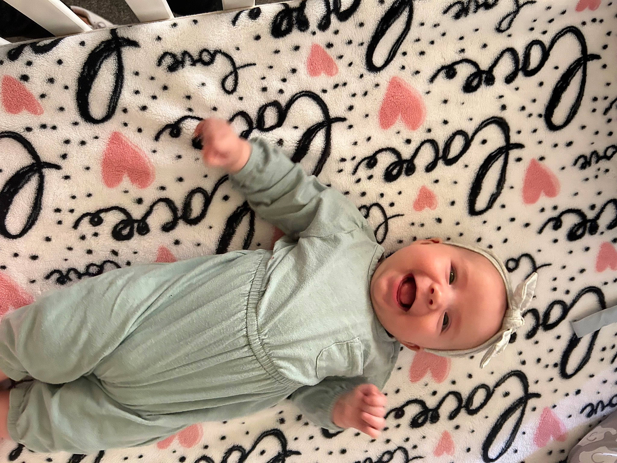 Maelynn is registered to the contest to win money with this photo: baby, baby_products, baby_safety, baby_toddler_clothing, bed, bedding, cheek, child, comfort, font, happy, linens, pattern, person, pink, product, room, sleeve, smile, textile