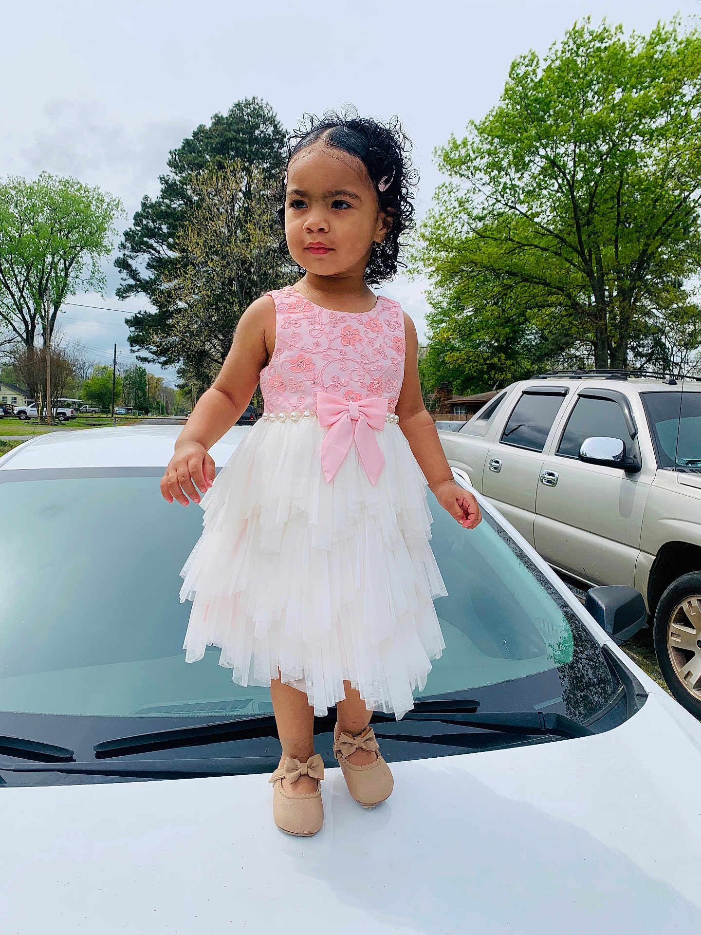 Aaliyah is registered to the contest to win money with this photo: blackhair, car, child, clothing, dress, eveningdress, face, female, formalwear, girl, head, person, photography, portrait, sitting, skirt, sleeve, standing, transportation, vehicle