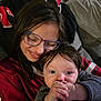 Eddie is registered to the contest to win money with this photo: child, baby, glasses, smile, couch, indoor, portrait, happy, person, hair, hand, clothing, sitting, family, toddler, cozy, relax, young, love, affection