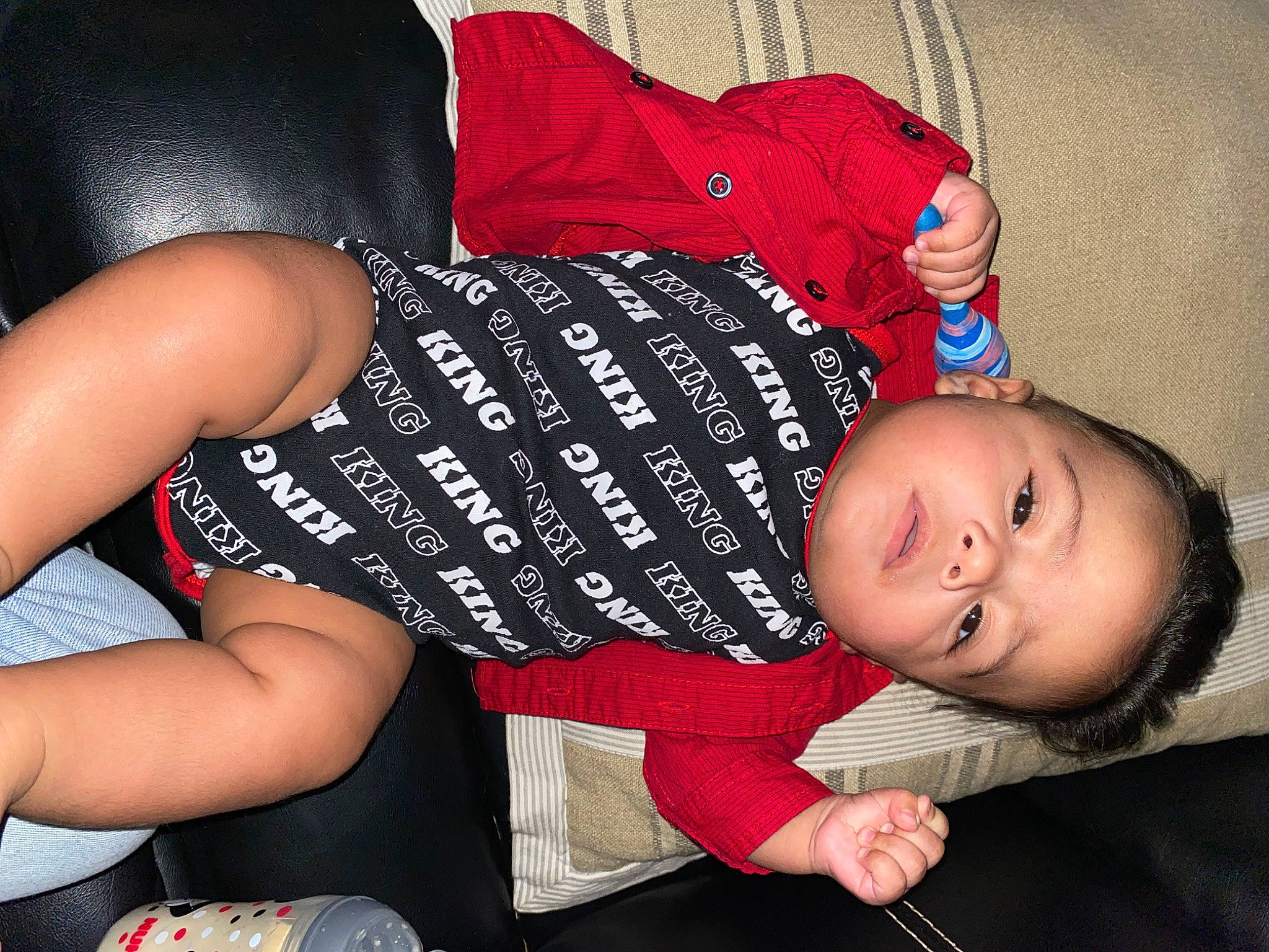 Kyng joined the competition — help win amazing prizes! arm, baby_toddler_clothing, black_hair, comfort, elbow, facial_expression, happy, human_body, human_leg, joint, knee, lap, leg, mouth, nail, person, pink, sitting, thigh, toddler