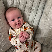 Stetson joined the competition — help win amazing prizes! baby, infant, smiling, onesie, turkey_pattern, cute, happy, child, soft_blanket, plush, indoors, portrait, sitting, hands, face, blue_eyes, cozy, candid, closeup, young