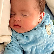 Samuel is registered to the contest to win money with this photo: baby, sleeping, blue_onesie, infant, face, pillow, closeup, peaceful, cute, child, soft, nap, portrait, skin, head, ear, clothing, rest, newborn, sleep