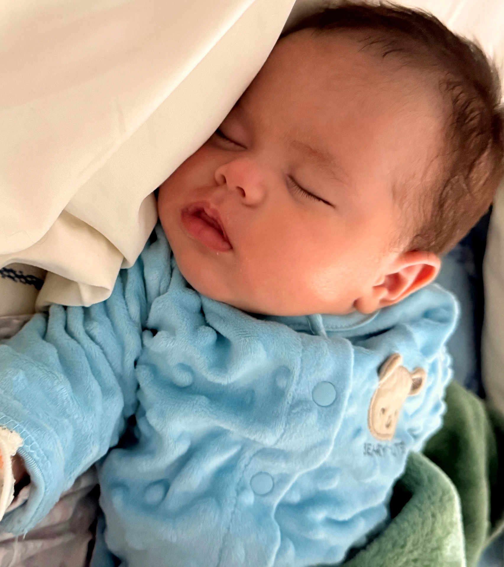 Samuel is registered to the contest to win money with this photo: baby, sleeping, blue_clothing, blanket, infant, face, peaceful, cute, soft, cozy, indoors, child, newborn, resting, portrait, young, warm, comfortable, cute_baby, nap