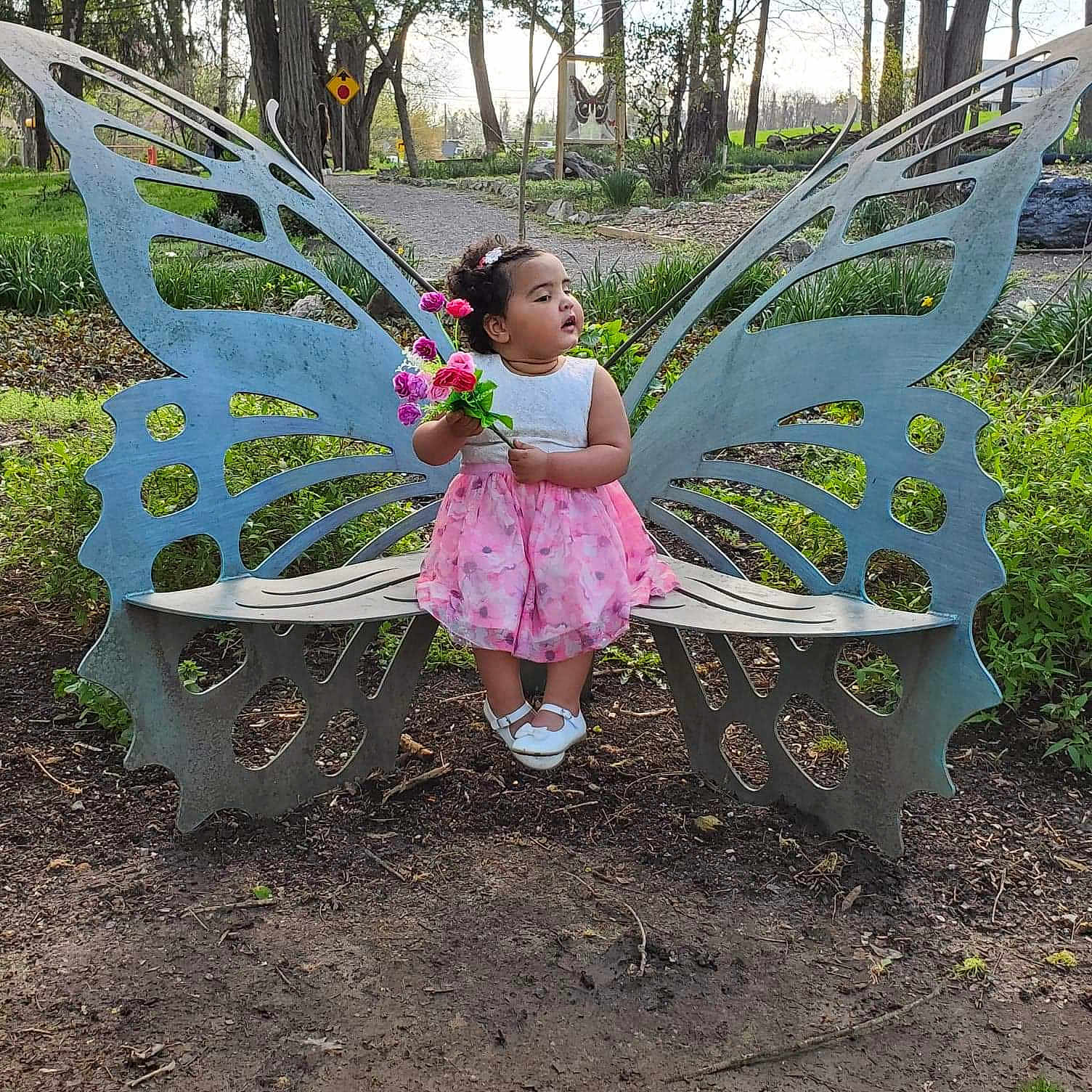 Terri joined the competition — help win amazing prizes! adaptation, botany, child, dress, fictional_character, flower, garden, grass, leaf, leisure, outdoor_play_equipment, person, plant, play, soil, spring, toddler, tree, wildflower, yard