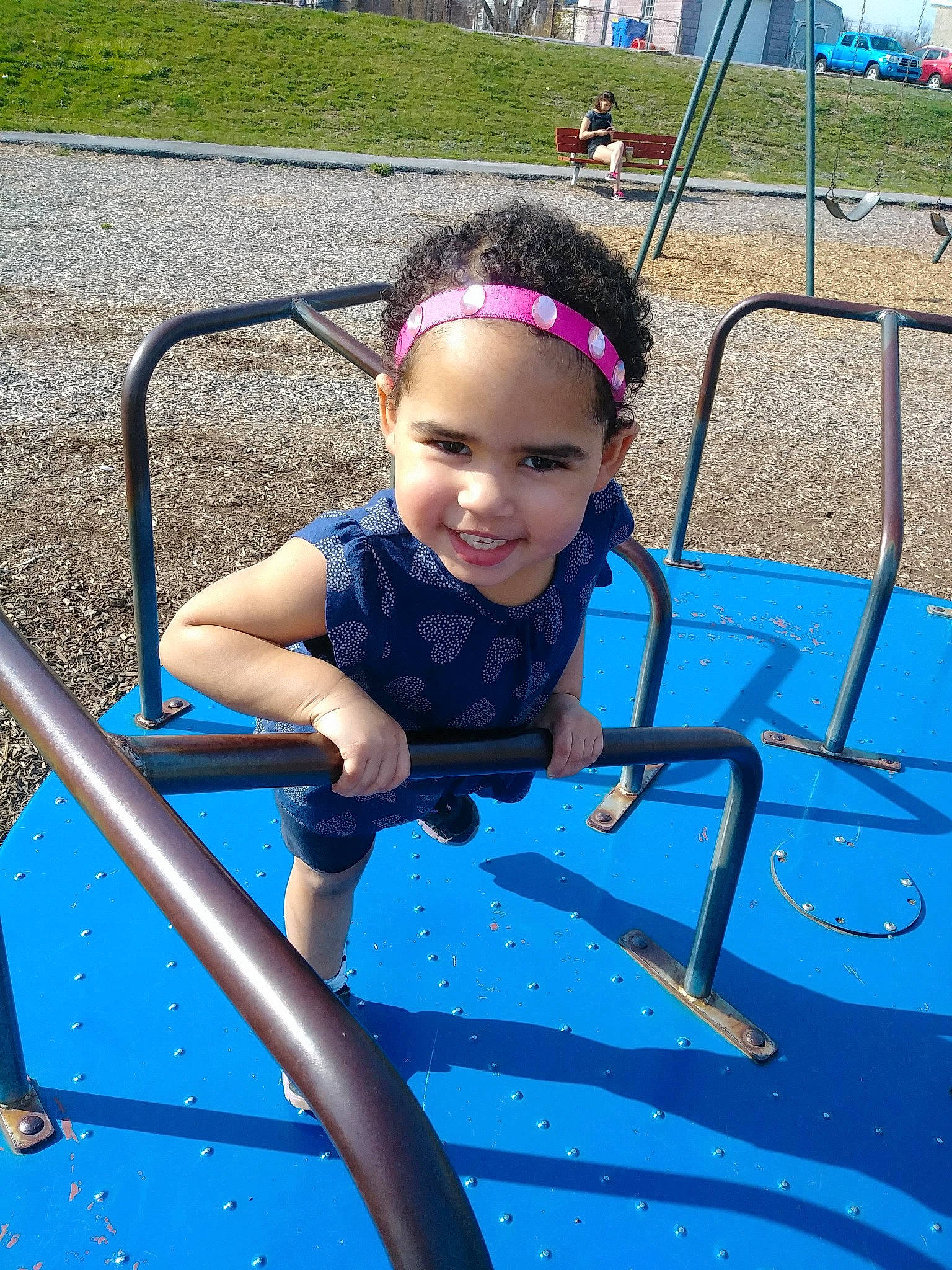 Anna is registered to the contest to win money with this photo: child, city, electric_blue, fun, human_settlement, joy, leisure, outdoor_play_equipment, person, play, playground, public_space, recreation, smile, summer, swing, toddler, vacation