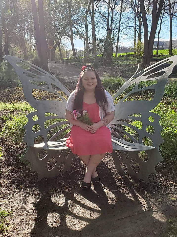 Akilliana is registered to the contest to win money with this photo: dress, fawn, grass, joy, leaf, person, plant, sitting, tree