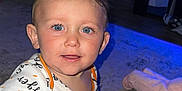 Rico joined the competition — help win amazing prizes! baby, baby_gate, blue_eyes, bracelet, carpet, casual, child, cute, floor, home, indoor, infant, light, onesie, pacifier, person, playful, smiling, toddler, toy