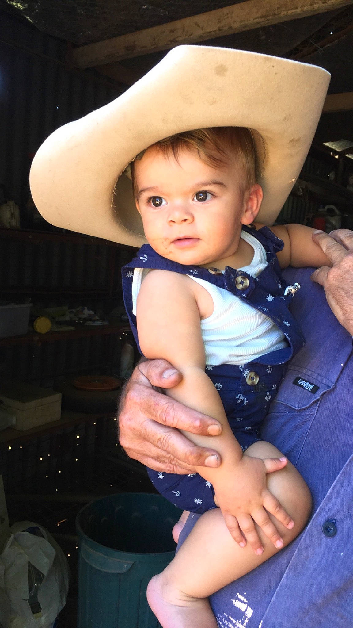Jakobi is registered to the contest to win money with this photo: baby, cheek, child, hand, hat, headgear, person, sitting, skin, smile, sun_hat, toddler