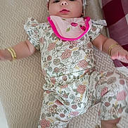 Kehlani joined the competition — help win amazing prizes! baby, child, infant, pajamas, floral_pattern, headband, bracelet, bib, bed, blanket, pattern, pink, ladybug, flower, sleepwear, cute, lying_down, indoors, person, toddler