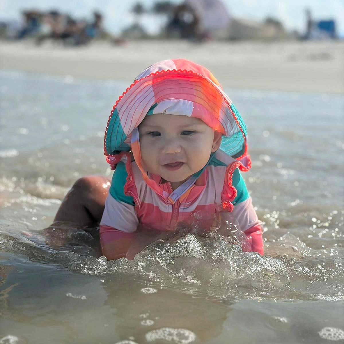 Zoe Paredes joined the competition — help win amazing prizes! baby, beach, child, childhood, fun, happy, nature, ocean, outdoor, playing, sand, splashing, summer, sun_hat, sunny, swimsuit, toddler, vacation, water, waves