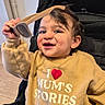 Matteo a rejoint le concours — aidez-le/la à gagner de superbes lots ! baby, child, childhood, cute, face, hair, hand, happy, indoor, joy, person, playful, seatbelt, smiling, stroller, sunglasses, sweater, toddler, toy, yellow_clothing