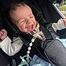Jackson joined the competition — help win amazing prizes! baby, infant, child, smiling, laughing, stroller, car_seat, harness, blanket, pacifier, toy, portrait, close_up, outdoor, sunlight, vehicle, seated, happy, casual_clothing, face