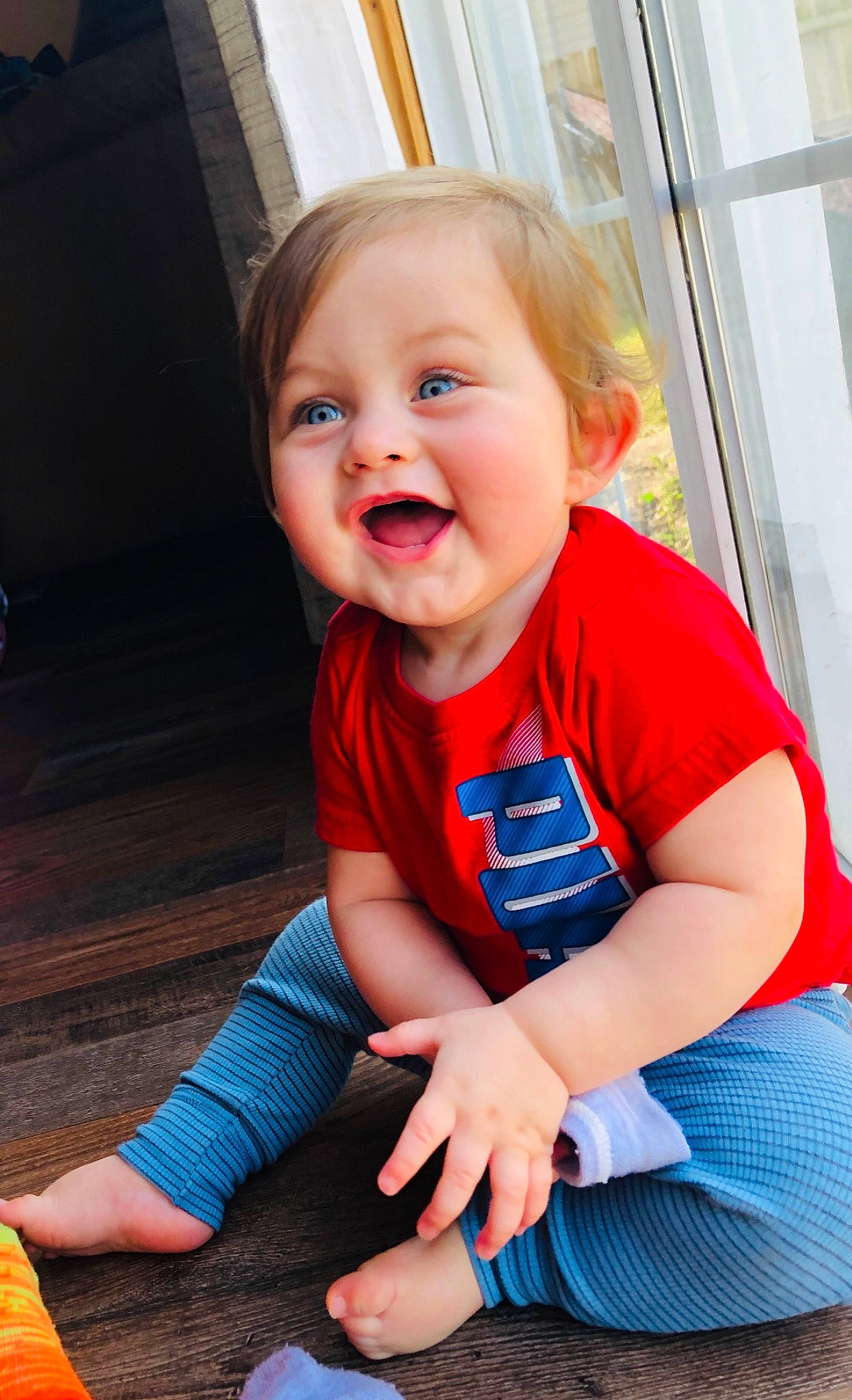 Kooper is registered to the contest to win money with this photo: baby, baby_toddler_clothing, blue, cheek, child, face, facial_expression, laugh, person, play, product, red, sitting, skin, smile, standing, toddler