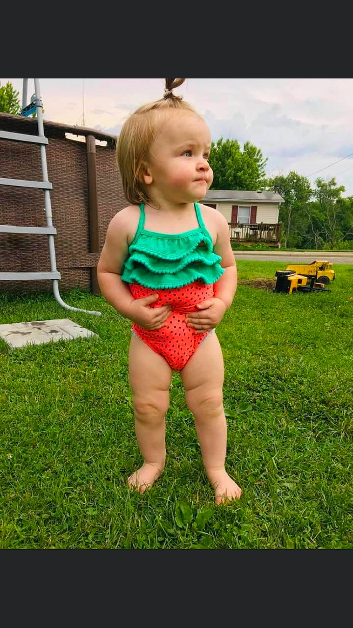 Emerlynn is registered to the contest to win money with this photo: barefoot, child, child_model, clothing, grass, lawn, one_piece_swimsuit, pattern, person, plant, play, summer, swimwear, toddler, vacation