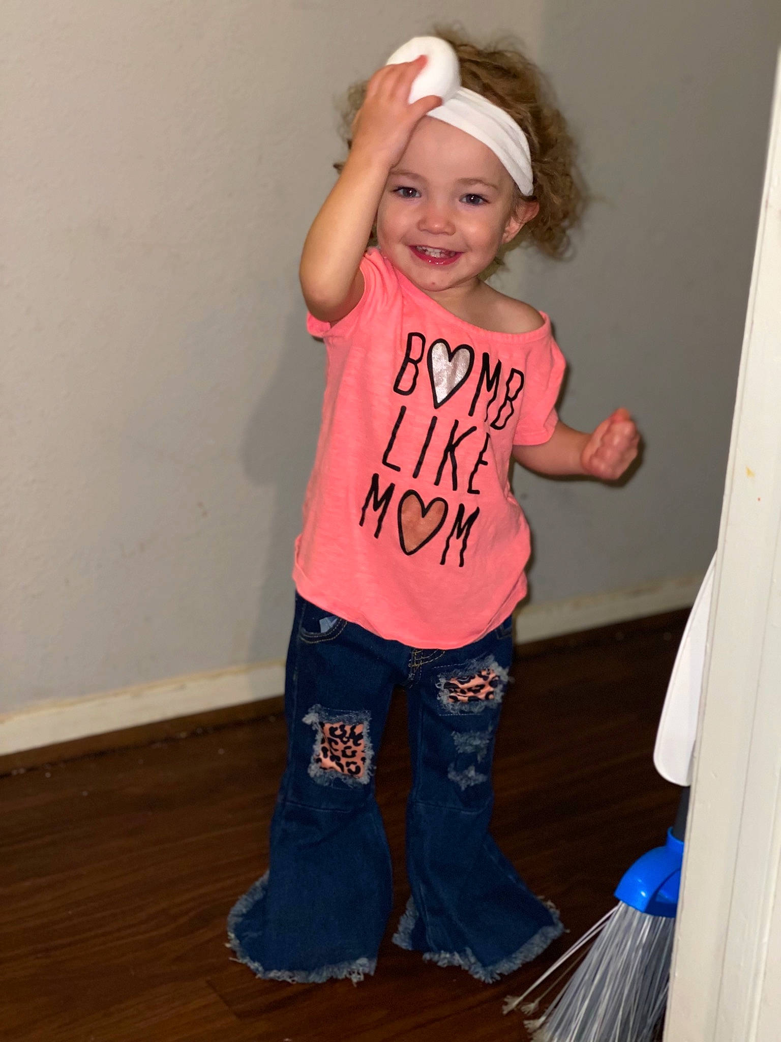 Ivy is registered to the contest to win money with this photo: baby_toddler_clothing, child, denim, electric_blue, flooring, fun, hairstyle, happy, hardwood, headwear, joy, knee, person, pink, room, sleeve, smile, t_shirt, thigh, toddler