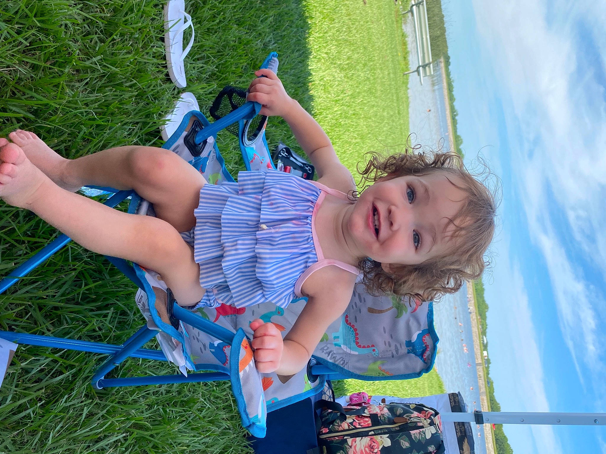 Ivy is registered to the contest to win money with this photo: barefoot, blue, child, cloud, electric_blue, fun, grass, happy, human_body, human_settlement, joy, leisure, outdoor_play_equipment, people_in_nature, person, public_space, recreation, sky, summer, swing