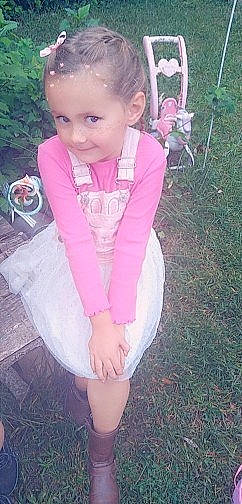 Faithann is registered to the contest to win money with this photo: baby_toddler_clothing, clothing, dress, eye, face, facial_expression, grass, green, hair, happy, head, jacket, joy, lip, outerwear, person, pink, plant, shorts, skin