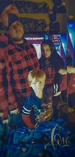 Dalton is registered to the contest to win money with this photo: art, child, christmas_eve, event, fun, headwear, lap, pattern, person, plaid, recreation, room, shorts, sitting, sky, sleeve, square, t_shirt, tartan, toddler