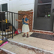 Riley joined the competition — help win amazing prizes! toddler, child, dress, denim_vest, boots, porch, stairs, railing, brick_wall, door, window, concrete, smiling, outdoor, handrail, steps, person, clothing, daylight, front_porch