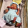 Sylvia joined the competition — help win amazing prizes! newborn, baby, infant, blue_dress, headband, blanket, hospital_bassinet, sleeping, smiling, feet, wrinkled_skin, name_card, textile, cute, portrait, indoors, person, baby_clothes, cozy, hospital