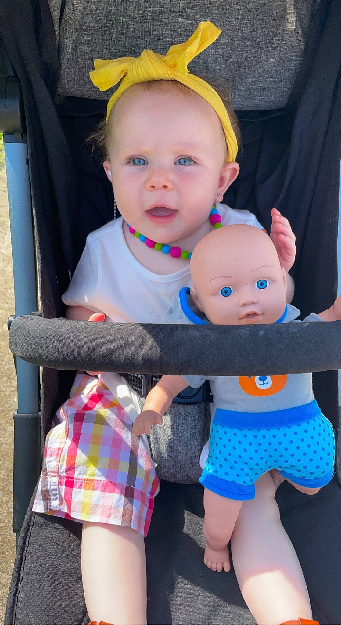Oakley joined the competition — help win amazing prizes! baby, baby_toddler_clothing, clothing, eye, face, facial_expression, gesture, green, hairstyle, hand, happy, head, person, photograph, pink, product, shorts, skin, tartan, white